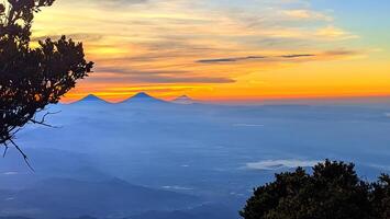 morning sunrise light at the top of Mount Slamet with a background of colorful sky light patterns photo
