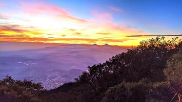 morning sunrise light at the top of Mount Slamet with a background of colorful sky light patterns photo