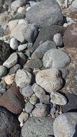 A collection of medium-sized river rocks is usually used as a mixture of building construction materials photo