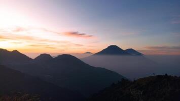 Natural views of Mount Sindoro and Mount Sumbing taken from the peak of Mount Bismo, Dieng, Wonosobo, Central Java in the morning, suitable for use as a natural background photo