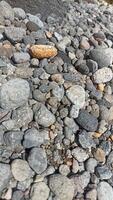 A collection of medium-sized river rocks is usually used as a mixture of building construction materials photo