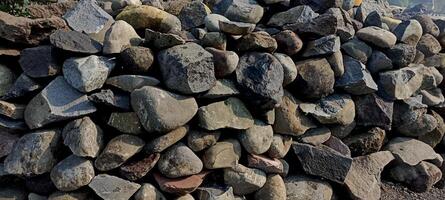 pile of stones that have been broken down and neatly arranged to be used for building foundations photo