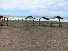 PURWOREJO CENTRAL JAVA INDONESIA APRIL 17 2024 view of Jatimalang beach which is equipped with huts around the beach photo