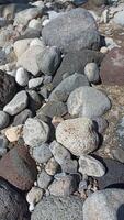 A collection of medium-sized river rocks is usually used as a mixture of building construction materials photo