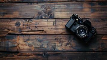 Camera lying on a wooden plain surface on beautiful background, top view photo