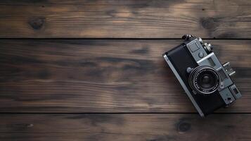 Camera lying on a wooden plain surface on beautiful background, top view photo