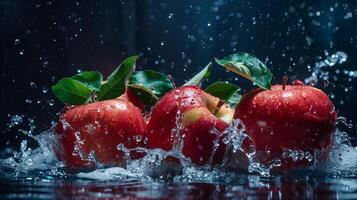 Apples with leaves and splashes of water on a monochrome background photo
