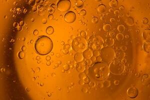 Yellow bubbles and drops of oil background, kitchen pattern, orange beverage background. photo
