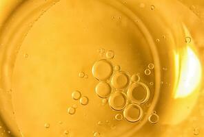 Yellow bubbles and drops of oil background, kitchen pattern, orange beverage background. photo