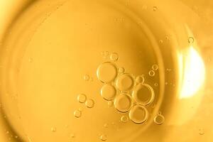 Yellow bubbles and drops of oil background, kitchen pattern, orange beverage background. photo