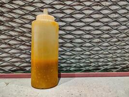 a bottle of ketchup and chili sauce at a fast food restaurant photo