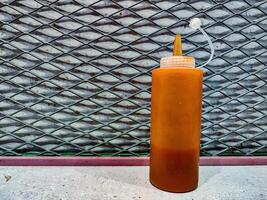 a bottle of ketchup and chili sauce at a fast food restaurant photo