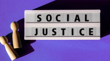 Lightbox with message SOCIAL JUSTICE. Motivational Words Quotes Concept. Colorful blue background. Minimalistic creative concept. Concept of Diversity inclusion equality identity equity belonging empathy video