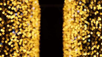 Defocused pulsating colorful lights bokeh against dark background. Abstract bokeh holiday background. Presentation Party Bokeh Effect. Yellow and orange Christmas and New Year colors video
