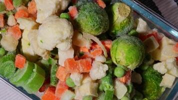 Frozen mixed vegetables for long-term storage. Stocking up vegetables for winter storage. Deep freezing of vegetables. defrosting Assortment of frozen vegetables video
