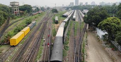 Surface level of railway tracks along green plants photo