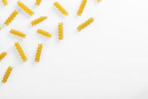 Pasta products in the form of a spiral, texture, on a white background photo