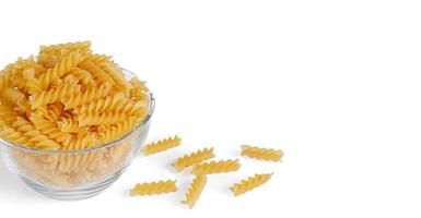 Pasta products in the form of a spiral on a plate, texture, on a white background photo