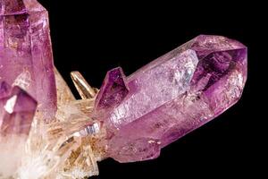 Macro of amethyst mineral stone on black background photo