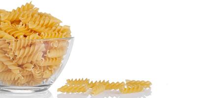 Pasta products in the form of a spiral on a plate, texture, on a white background photo