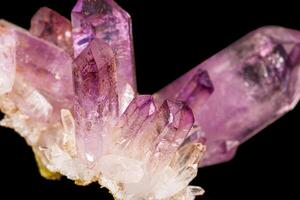 Macro of amethyst mineral stone on black background photo