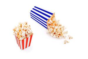 Glass with popcorn on a white background photo
