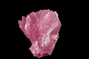 Macro pink quartz mineral stone on black background photo