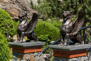Two statues of griffins photo