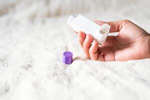 Woman holding asthma inhaler applying for prevent asthma attack. photo