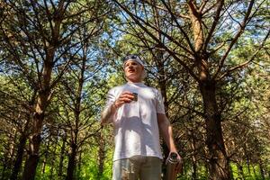 Man taking a break during walk in the woods. photo