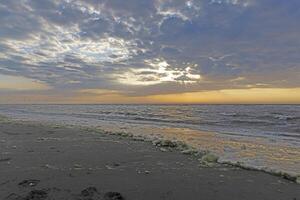 Panoramic picture over the beach of Ouddorp in Holland in the evening during sunset photo