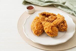 fried chicken with ketchup on plate photo