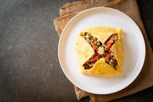 egg wrap or stuffed egg with minced pork and vegetable photo