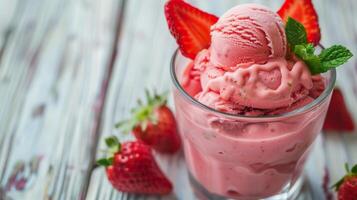 Close up of a tantalizing glass filled with strawberry ice cream, adorned with fresh strawberries photo