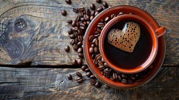 Cozy cup of coffee with heart shaped foam surrounded by coffee beans on a wooden table photo