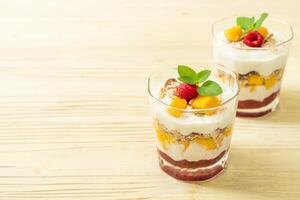 homemade mango and raspberry with yogurt and granola photo