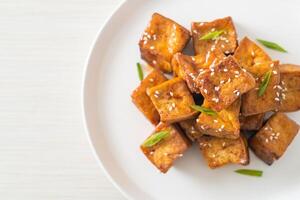fried tofu with white sesame and teriyaki sauce photo
