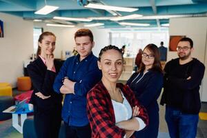 Portrait of a successful creative businessman and businesswoman looking at camera and smiling. Diverse business people standing together at startup. photo