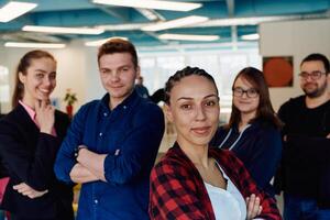 Portrait of a successful creative businessman and businesswoman looking at camera and smiling. Diverse business people standing together at startup. photo