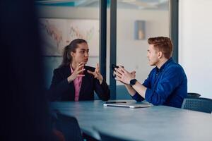 A business leader in a suit conversing with her worker in the IT industry about new business projects and existing business problems photo