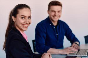 A business leader in a suit conversing with her worker in the IT industry about new business projects and existing business problems photo