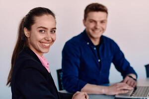 A business leader in a suit conversing with her worker in the IT industry about new business projects and existing business problems photo