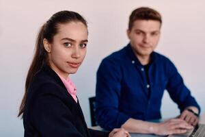 A business leader in a suit conversing with her worker in the IT industry about new business projects and existing business problems photo