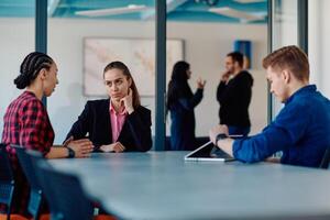 A team of successful programmers sits in a startup office, strategizing new business projects and solving existing challenges, showcasing innovation and collaboration in the tech industry photo