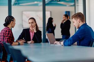 A team of successful programmers sits in a startup office, strategizing new business projects and solving existing challenges, showcasing innovation and collaboration in the tech industry photo