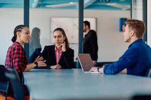 A team of successful programmers sits in a startup office, strategizing new business projects and solving existing challenges, showcasing innovation and collaboration in the tech industry photo