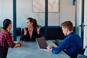 A team of successful programmers sits in a startup office, strategizing new business projects and solving existing challenges, showcasing innovation and collaboration in the tech industry photo
