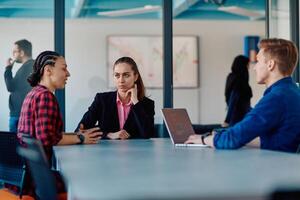 A team of successful programmers sits in a startup office, strategizing new business projects and solving existing challenges, showcasing innovation and collaboration in the tech industry photo