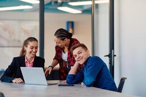 A team of successful programmers sits in a startup office, strategizing new business projects and solving existing challenges, showcasing innovation and collaboration in the tech industry photo