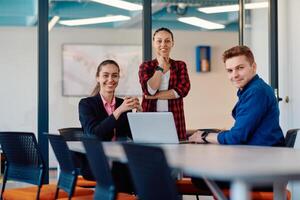 A team of successful programmers sits in a startup office, strategizing new business projects and solving existing challenges, showcasing innovation and collaboration in the tech industry photo